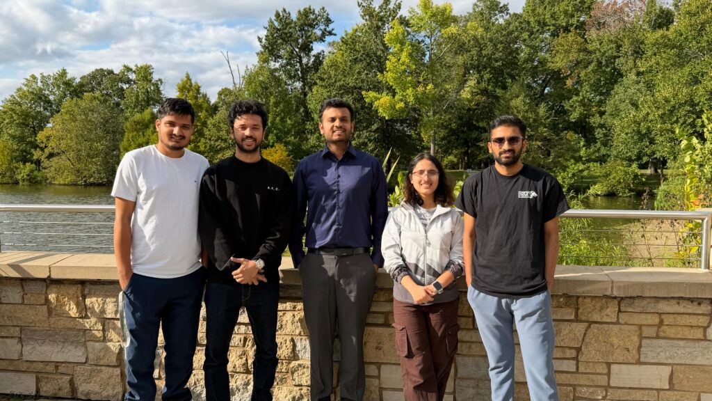 GeoCARE Lab members standing together outdoors by Campus Lake at SIU